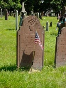 Grave stone with American flag.