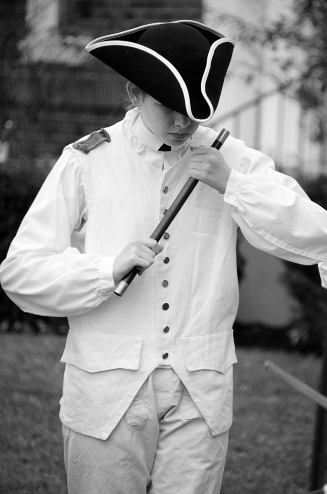 Young woman holding a fiddle.