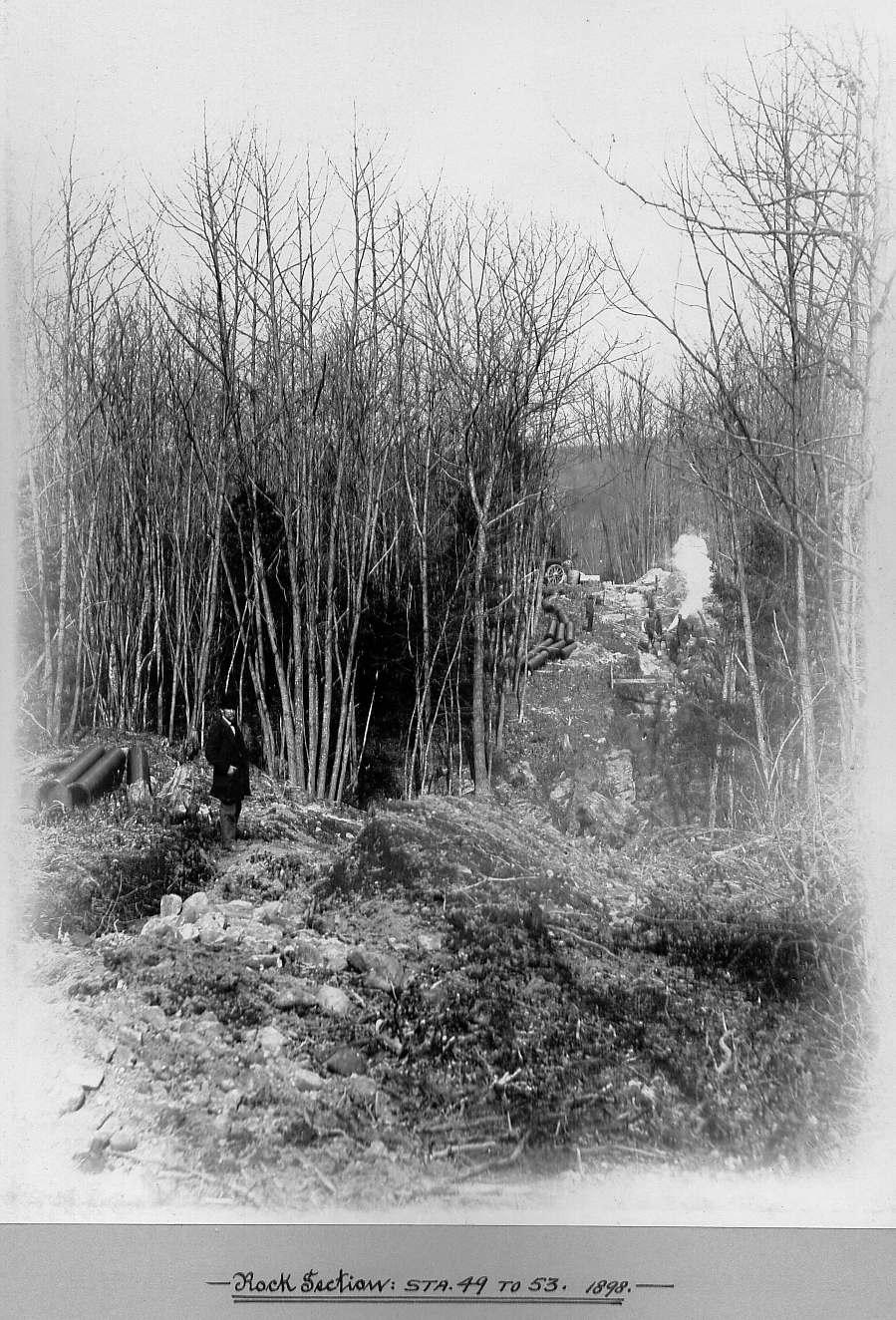 Man standing with pipes in rock section